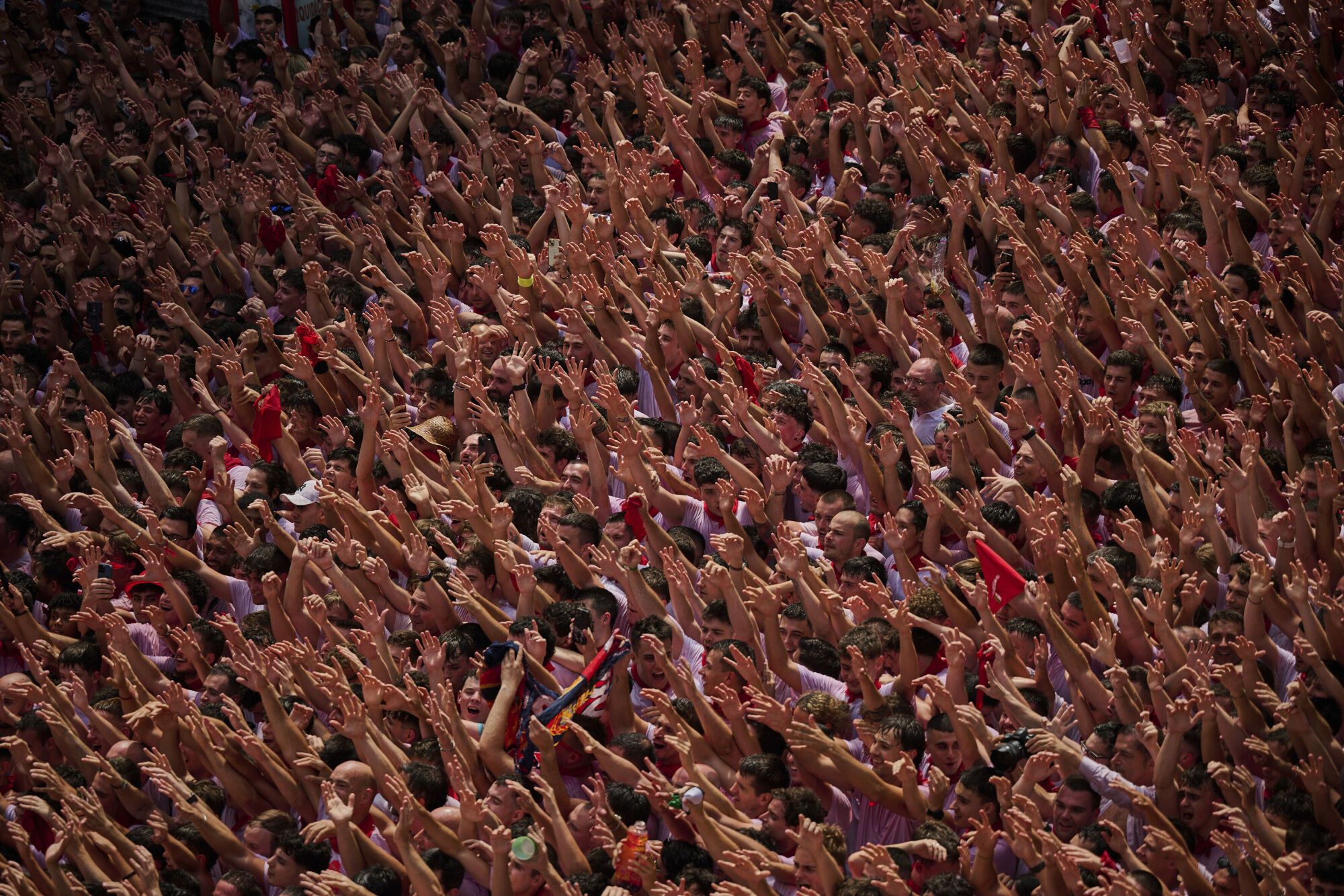Revelers pack the main square during the start of nine days of uninterrupted partying in Pamplona's famed running-of-the-bulls festival in Pamplona, Spain, Sunday, July 6, 2025. (AP Photo/Miguel Oses). EDITORIAL USE ONLY/ONLY ITALY AND SPAIN