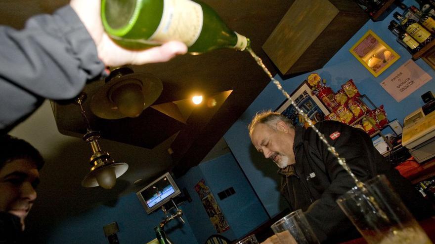 Un hombre sirve sidra del País Vasco en un bar de Astigarraga (Guipúzcoa). | Miki López