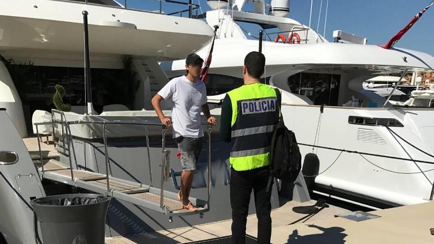 Un agente inspeccionando un tripulante de un yate anclado en Mallorca.