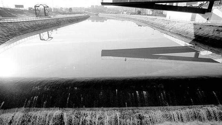 El azud del puente de San Sebastián y la lámina de agua estuarina que se extiende ría arriba en un tramo recuperado durante los últimos años para el disfrute ciudadano.