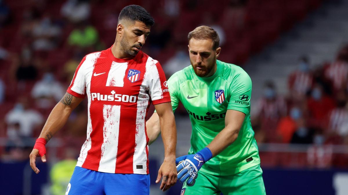 El portero esloveno del Atlético de Madrid Jan Oblak (d) y su compañero uruguayo Luis Suárez durante el partido de la segunda jornada de LaLiga que Atlético de Madrid y Elche CF juegan hoy domingo en el Wanda Metropolitano . EFE / Juan Carlos Hidalgo