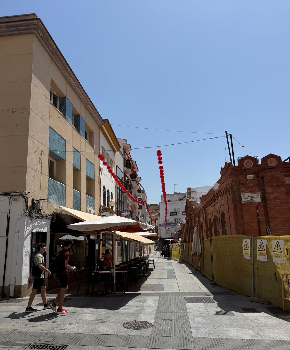 La feria todavía no ha comenzado, pero Mérida empieza a reconocerla cuando levanta la vista. Las primeras hileras de farolillos rojos han quedado suspendidas sobre algunas calles del centro este 18 de agosto, anticipando una transformación que irá ganando terreno conforme se acerque septiembre.  Quedan 14 días para el 1 de septiembre, fecha marcada para el comienzo de la Feria de Mérida, que se prolongará hasta el domingo 6. Seis jornadas festivas que empiezan a tener su primer reflejo en el corazón de la ciudad mucho antes de que se abran oficialmente.  Por el momento son solo algunos tramos, pero la decoración irá extendiéndose durante los próximos días por el resto de calles previstas y por la plaza de España, hasta completar la imagen que acompañará al centro durante las fiestas. Agosto encara así su recta final con una estampa cada vez más reconocible sobre las cabezas de vecinos, turistas y quienes estos días recorren la zona comercial.  ## La feria empieza por las alturas  Los farolillos se han convertido en una de las primeras señales visibles de que septiembre está cerca. Suspendidos de un lado a otro de la calle, las primeras tiras rojas rompen con la imagen habitual del centro y avanzan parte del ambiente que se instalará en la ciudad durante la primera semana del próximo mes.  El montaje se encuentra todavía en una fase inicial. Conforme pasen las jornadas, nuevos tramos irán incorporándose a la decoración y la presencia de los farolillos será más evidente en distintos puntos del casco urbano. La plaza de España también formará parte de ese proceso hasta completar la ornamentación prevista para estas fechas.  La transformación, por tanto, será progresiva. Lo que este martes son unas primeras líneas de color sobre algunas calles acabará formando parte del paisaje cotidiano del centro durante los días previos a la feria.  ## Dos semanas por delante  El calendario empieza a estrecharse. Del 18 de agosto al 1 de septiembre quedan exactamente dos semanas, un margen en el que la ciudad irá ultimando los preparativos para seis días de feria.  Mientras llega esa fecha, el centro ofrece el primer anticipo. Septiembre todavía queda al otro lado de agosto, pero la feria empieza a colgar sobre las calles de Mérida. Y esta vez la cuenta atrás puede verse simplemente mirando hacia arriba.