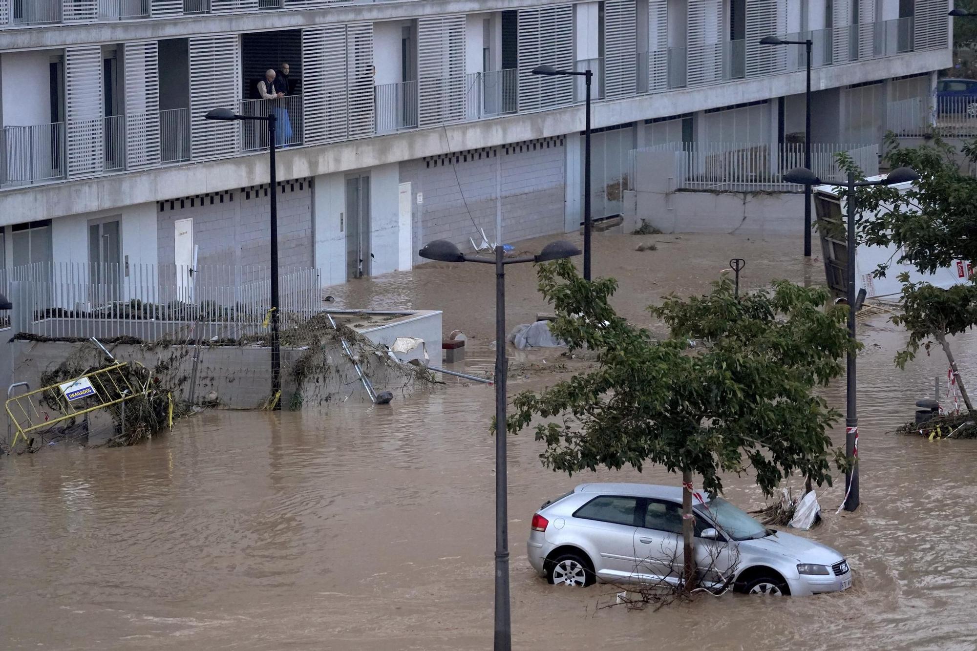 Cars are trapped by flooding in Valencia, Wednesday, Oct. 30, 2024. (AP Photo/Alberto Saiz)