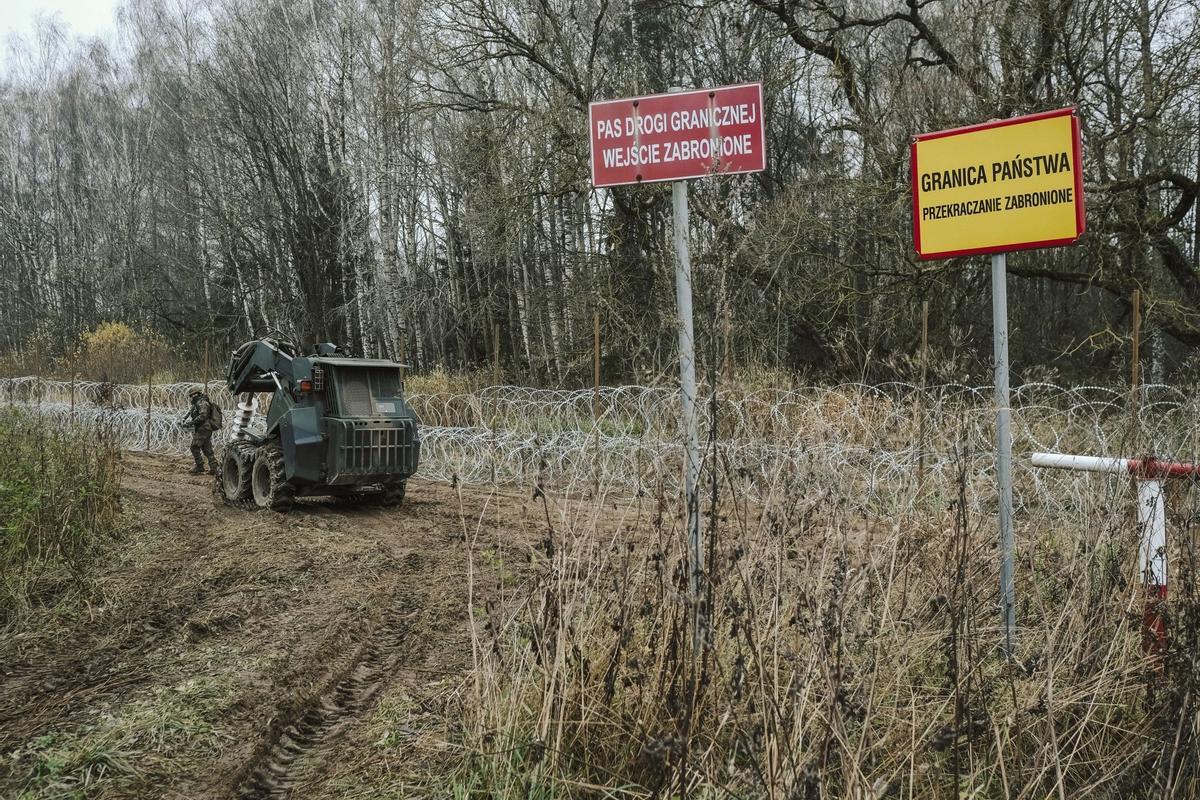 Soldados del ejército polaco arreglan bobinas de alambre de púas en una valla a lo largo de la frontera polaca, con el enclave ruso de Kaliningrado, cerca de Zerdziny, Polonia