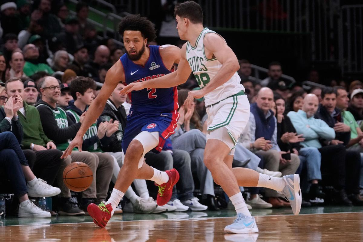 Detroit Pistons guard Cade Cunningham, left, drives to the basket against Boston Celtics guard Hugo Gonzalez, right, during the first half of an NBA basketball game, Monday, Dec. 15, 2025, in Boston. (AP Photo/Charles Krupa)