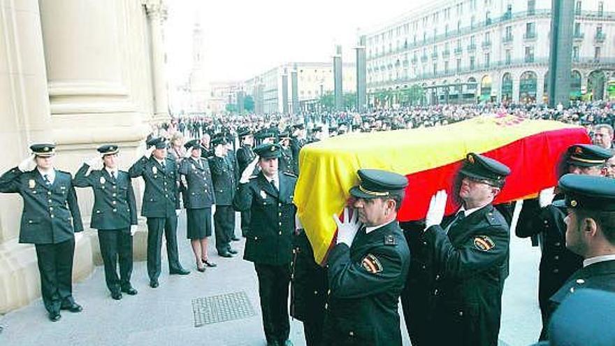 Compañeros de la subinspectora Rosa Crespo portan su féretro a la llegada a la basílica del Pilar, en Zaragoza.