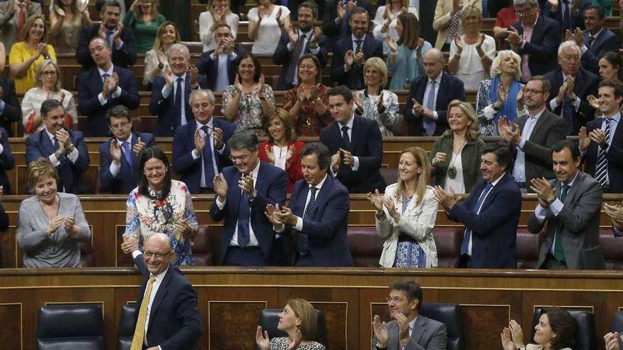 Los diputados del PP aplauden a Montoro tras la aprobación de las cuentas de 2017. // Efe