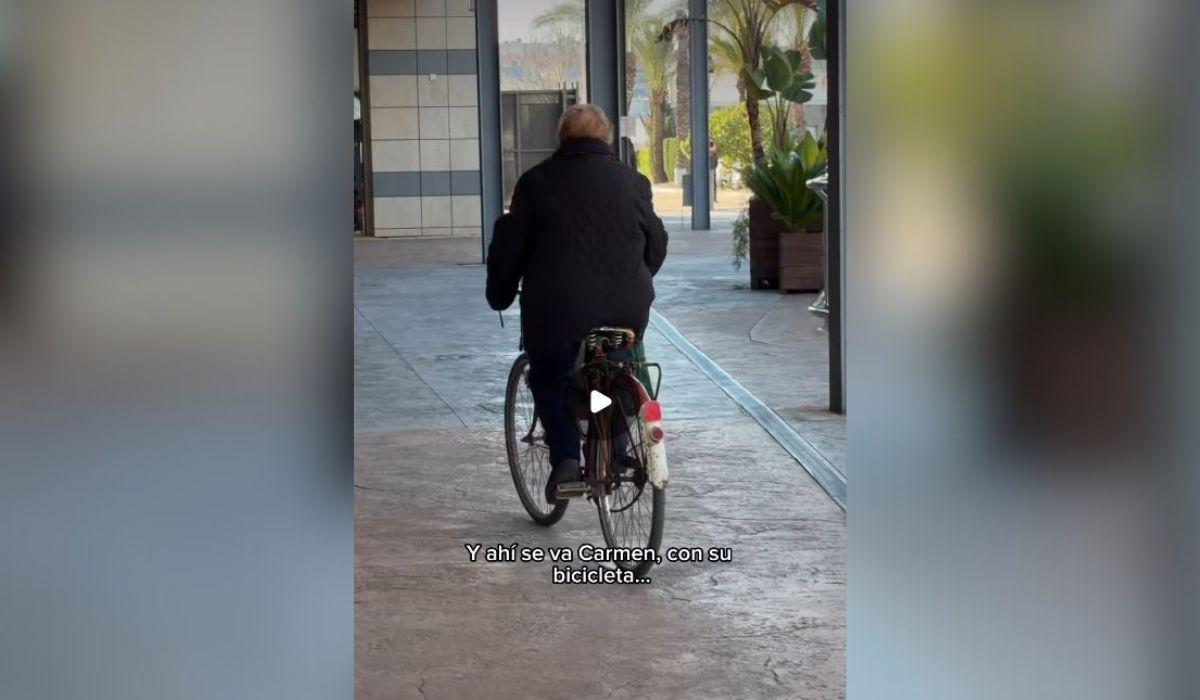 Carmen se marcha en su bicicleta, la misma que la acompaña desde hace más de seis décadas, tras hacer la compra en Orihuela.