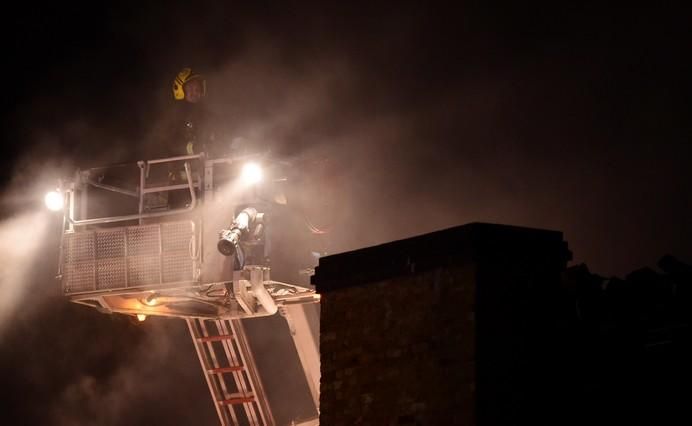 A firefighter tackles a fire at Camden Market in ...