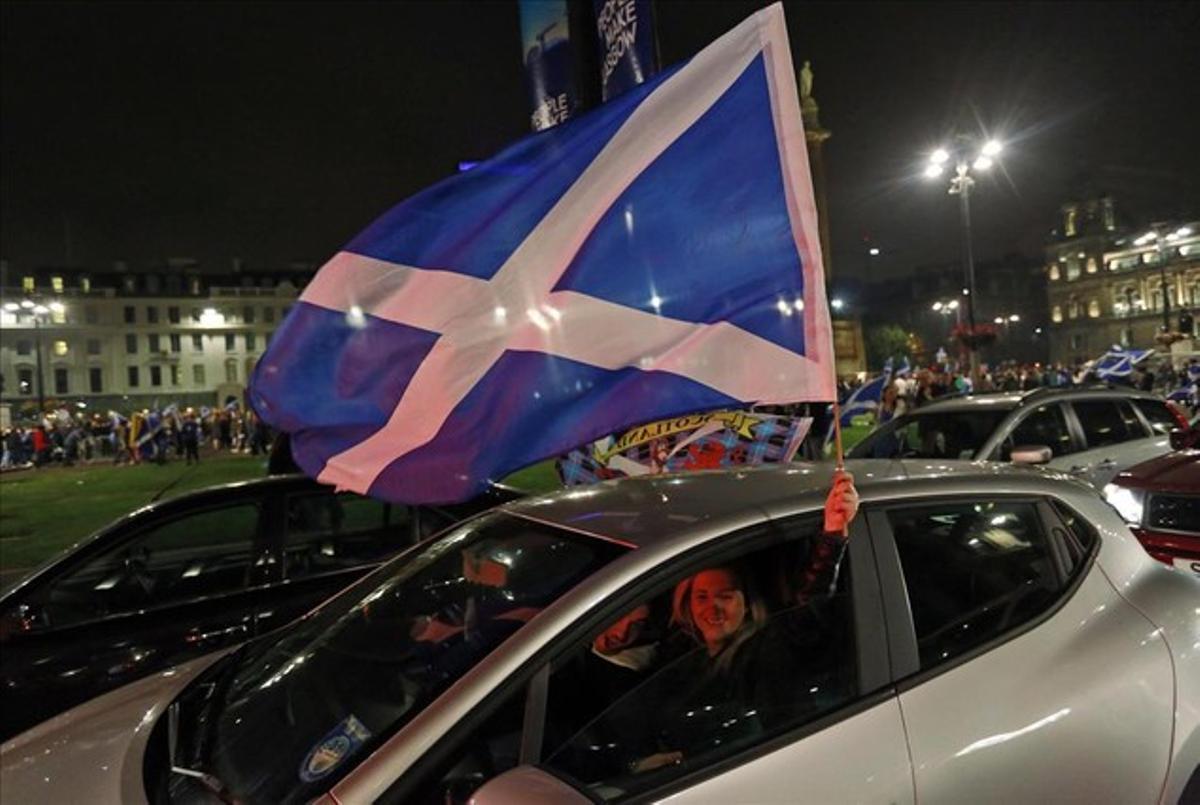 Partidarios de la independencia agitan una bandera de Escocia en el centro de Glasgow