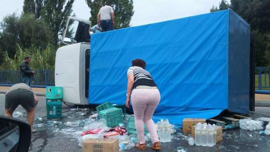 Varias personas recogieron la mercancía tras el accidente.