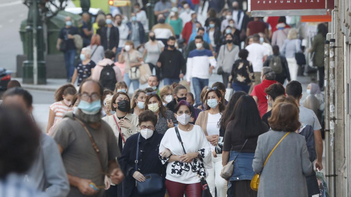 Personas caminando con mascarilla en la calle Príncipe de Vigo.