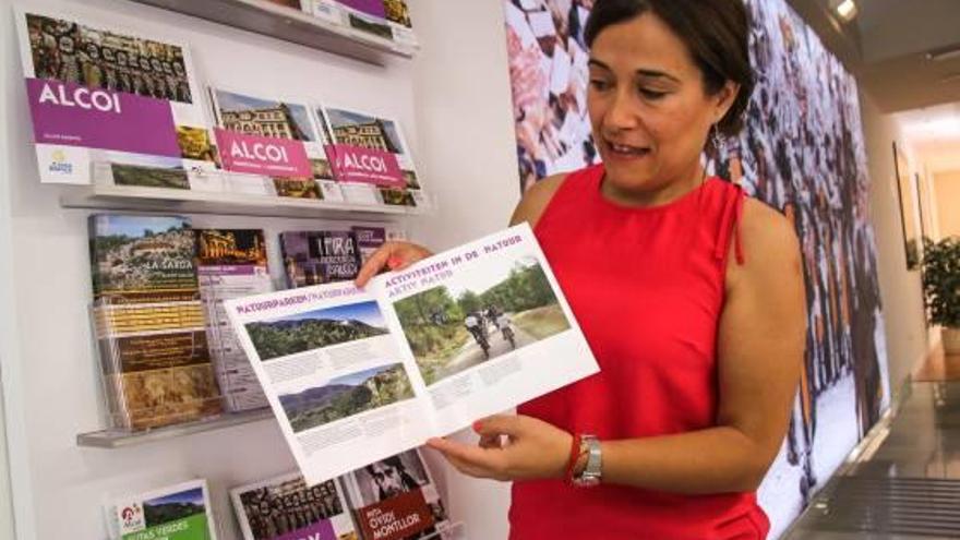 La concejala de Turismo revisando algunos de los folletos en otros idiomas.