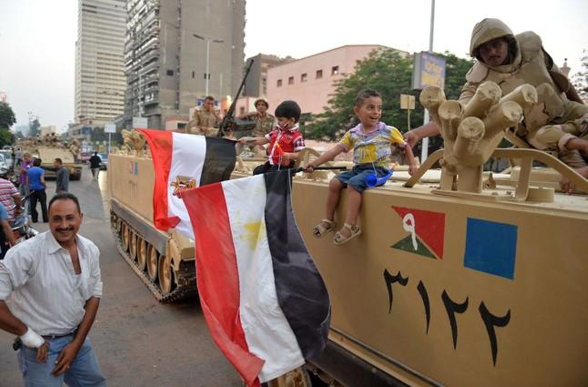 Un nen enfilat en un blindat de l’Exèrcit, al Caire.