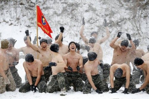 South Korean and U.S. Marines hurl snow during a winter military drill in Pyeongchang