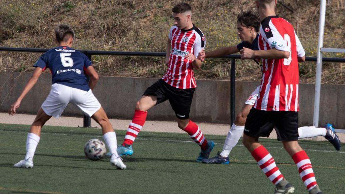 Un jugador rojiblanco realiza un pase ante la presión rival. | A. B.