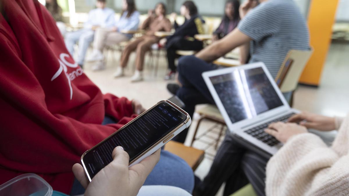 Un estudiante busca información en su móvil a la hora del patio en un instituto catalán.