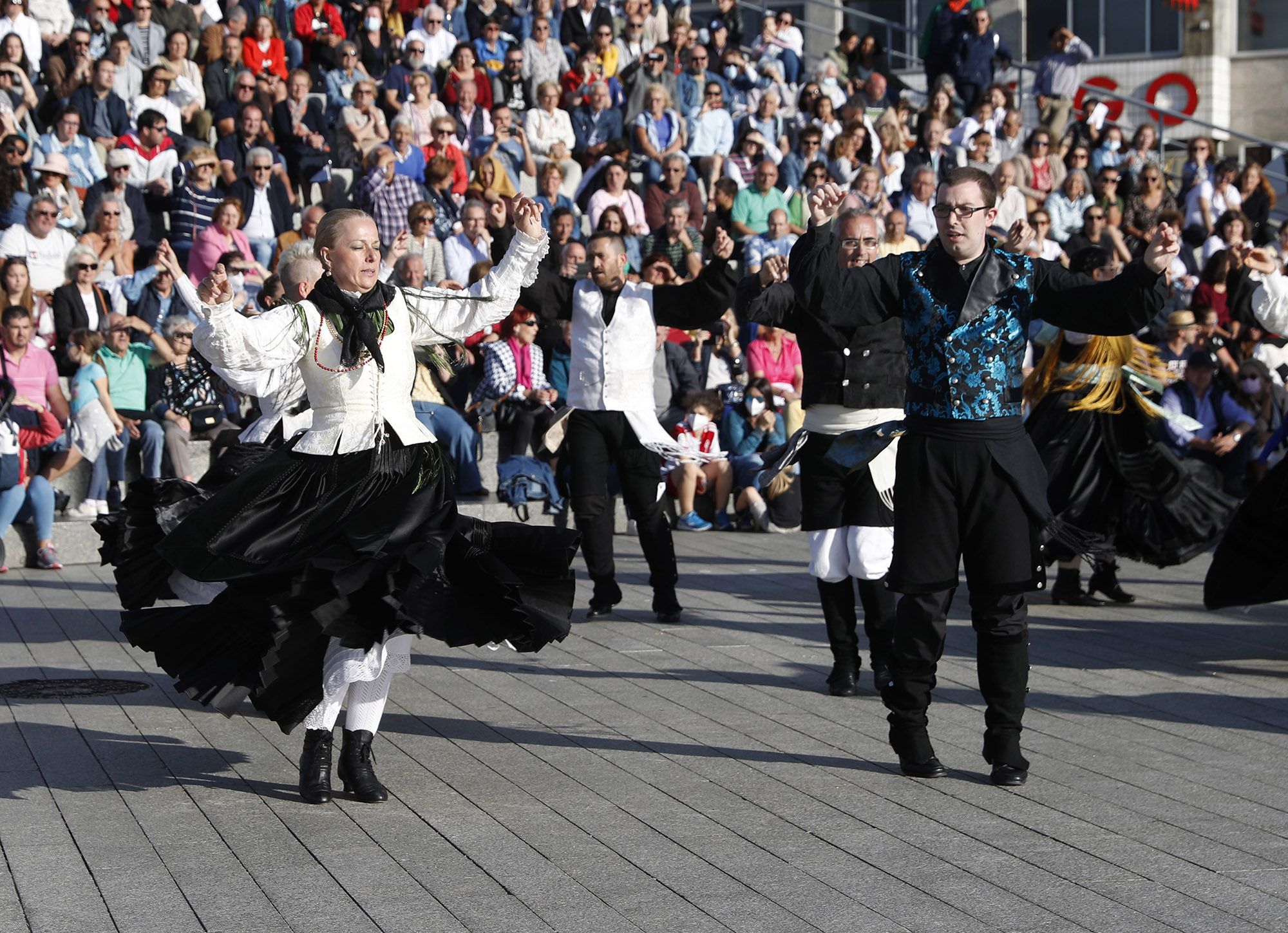 Bailarines y músicos durante la Festa da Muiñeira en el pase de As Avenidas