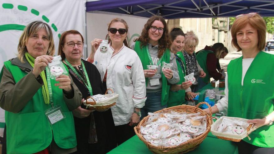 Voluntarias de las Asociación Española Contra el Cáncer y la Asociación de Pasteleros muestran los dulces.