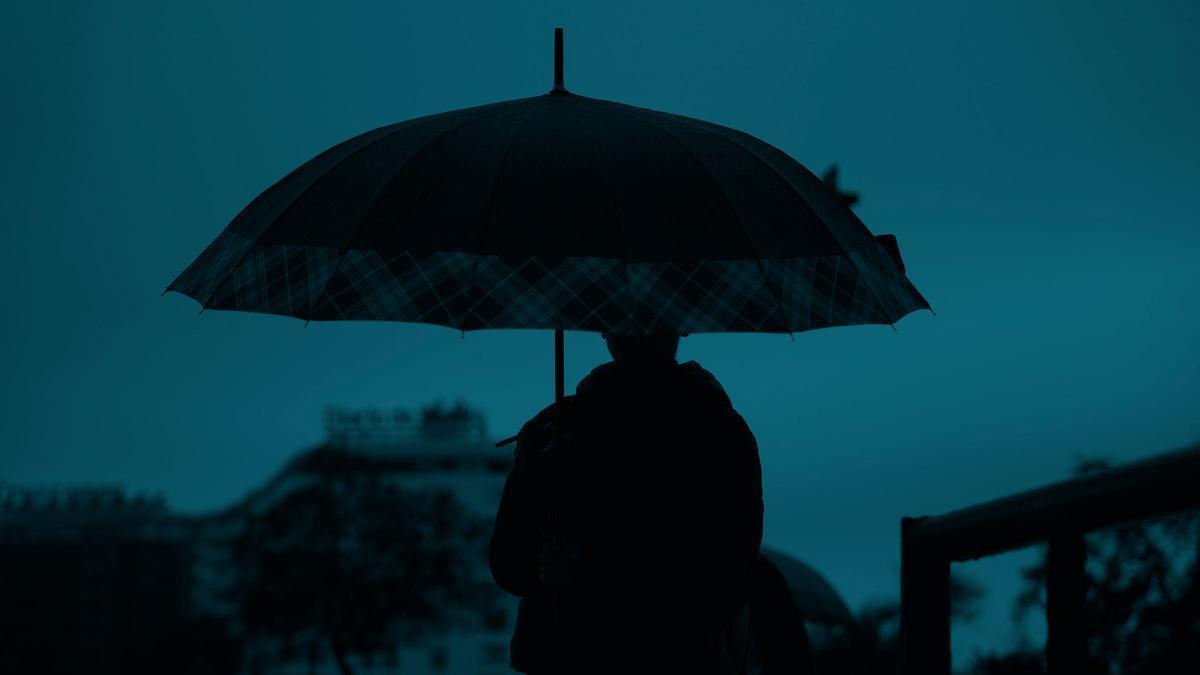 Peatones se protegen de la lluvia bajo sus paraguas, durante el paso de la borrasca Joseph el 27 de enero del 2026 en Sevilla.