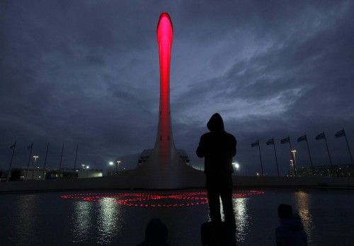 A lighting technician watches the rings form in a fountain at the base of the Olympic cauldron as preparations continue at the Olympic Park for the Sochi 2014 Winter Olympic