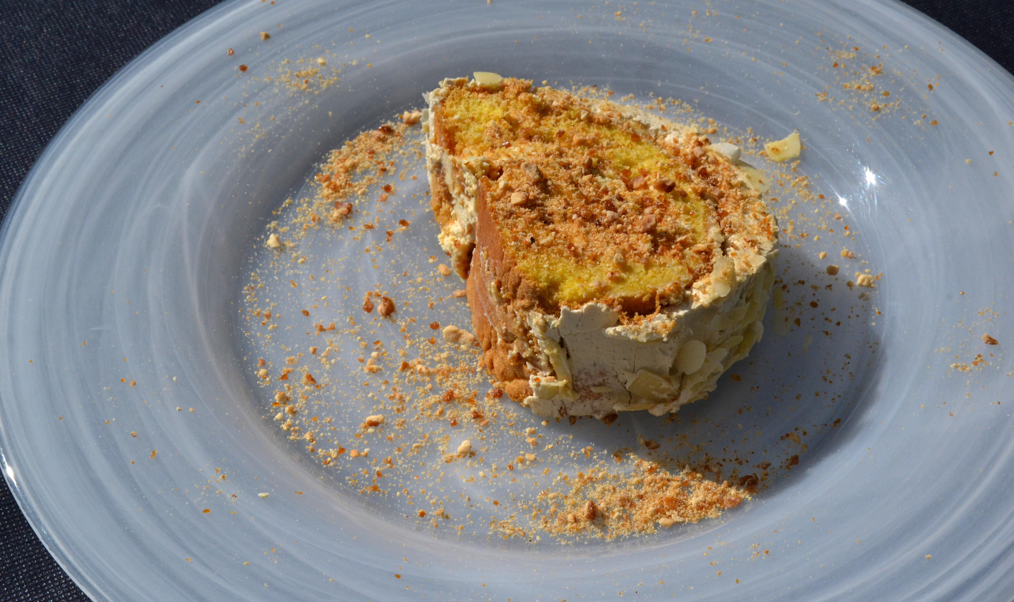 Tronco de mascarpone y turrón con una crema de mantequilla y cafe, con almendra garrapiñada.