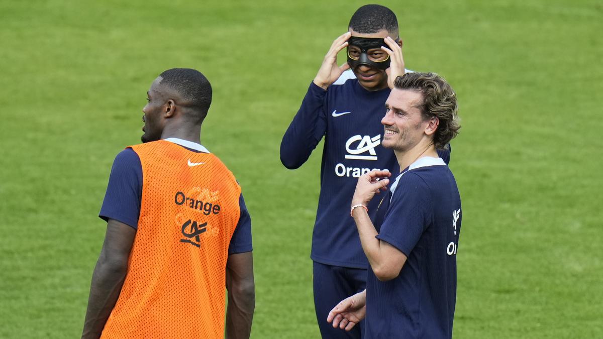 Kylian Mbappe y Antoine Griezmann, que están tocados, conversan en el entrenamiento de Francia