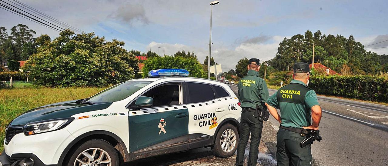 Una patrulla de la Guardia Civil, ayer en la recta de A Goulla (Meis).   | // IÑAKI ABELLA