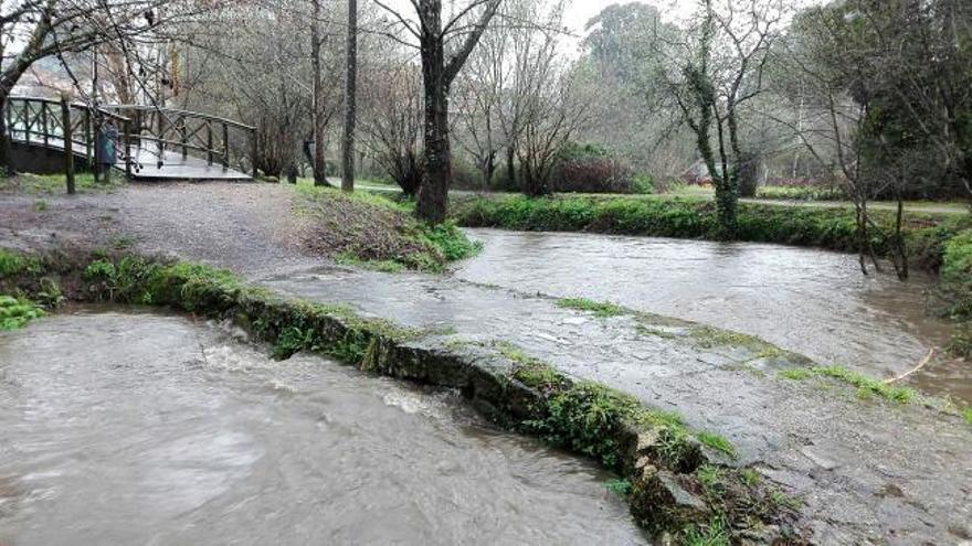 El Lagares, a punto de desbordarse, inunda uno de sus puentes romanos