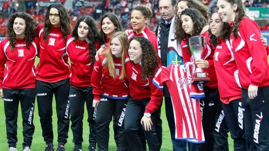 Las chicas del Hostelcur, con Quini, sobre el césped de El Molinón, recibiendo el homenaje de la grada.