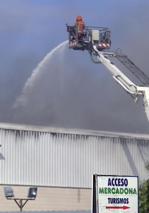 Los bomberos refrescan con agua la zona afectada para evitar que el fuego rebrote.