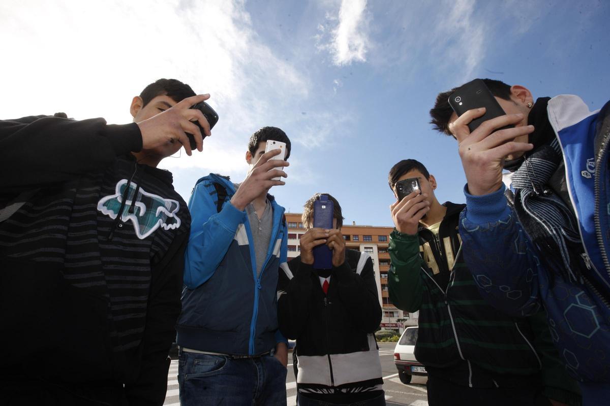 Imagen de archvio de adolescentes con sus móviles.