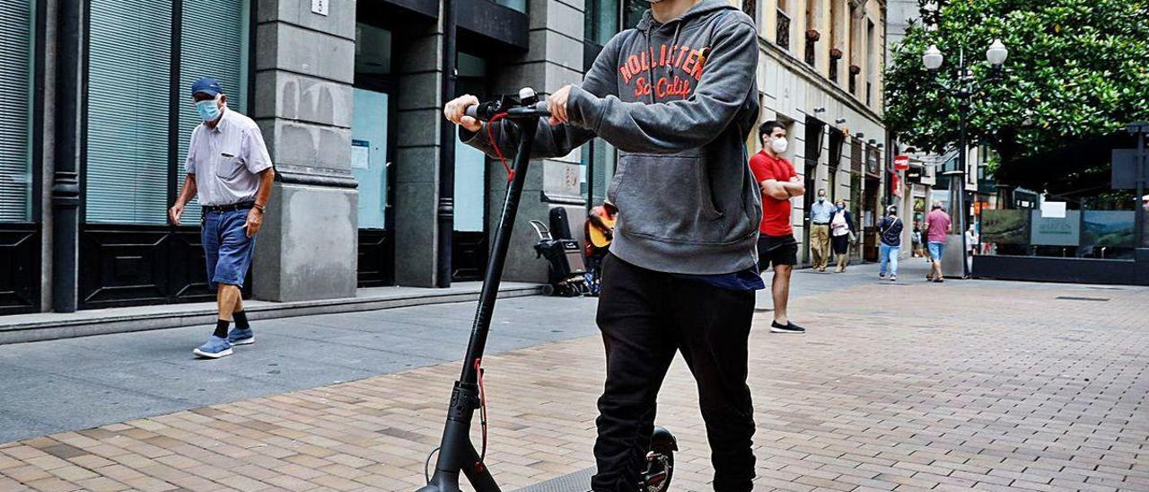 Alberto Vidal, con su patinete eléctrico, en la calle Corrida.