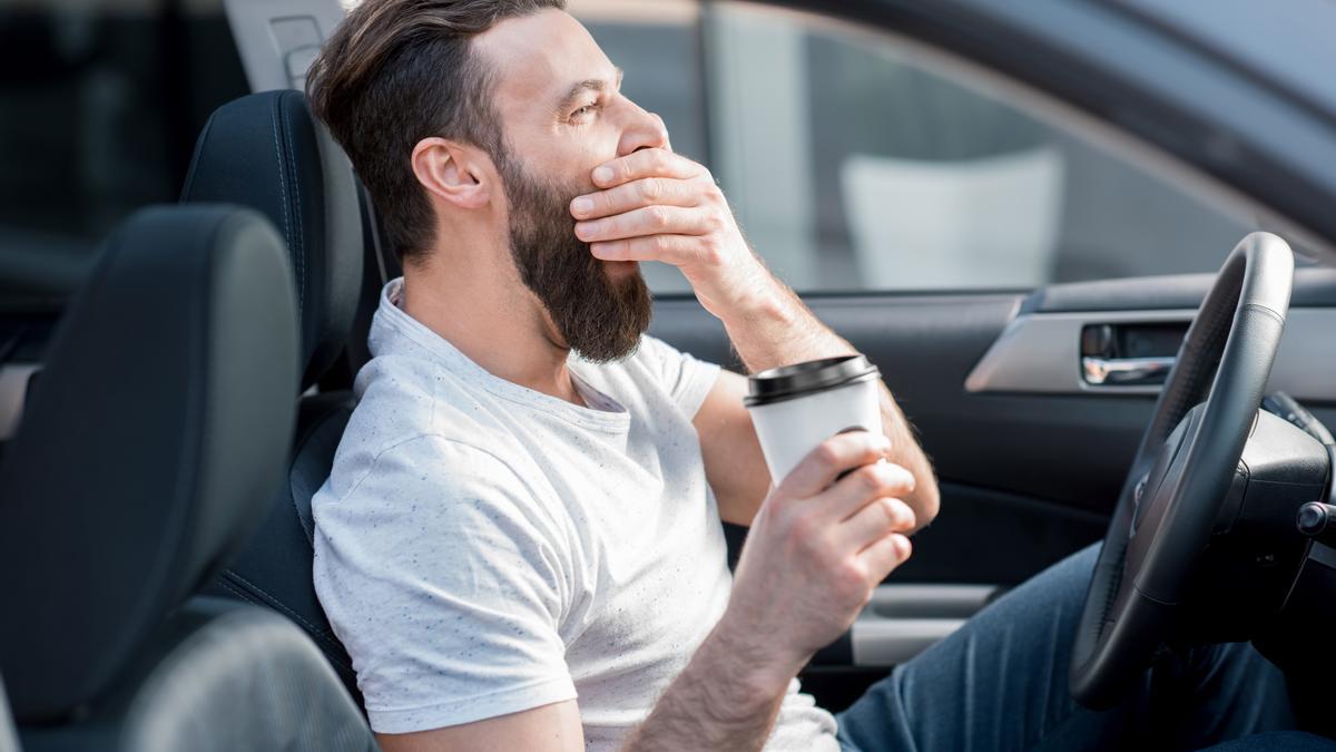 Tired man driving a car