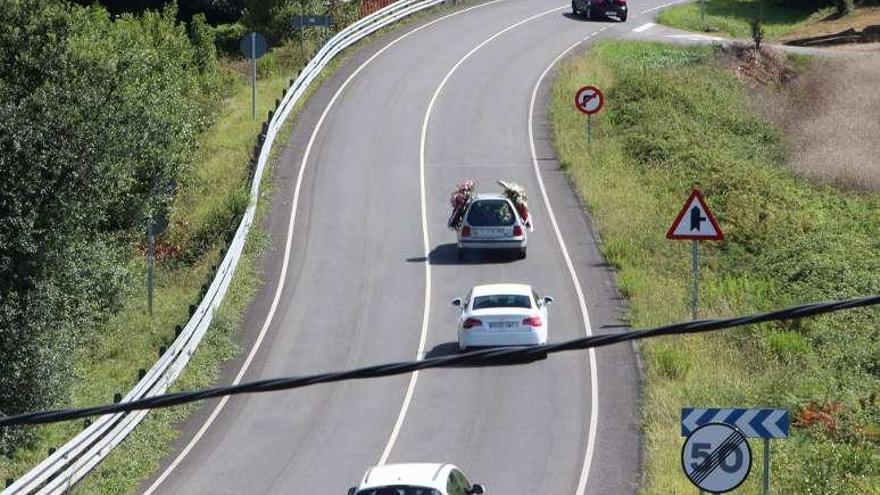 El coche fúnebre, ayer, dejando el tanatorio seguido de otros vehículos.