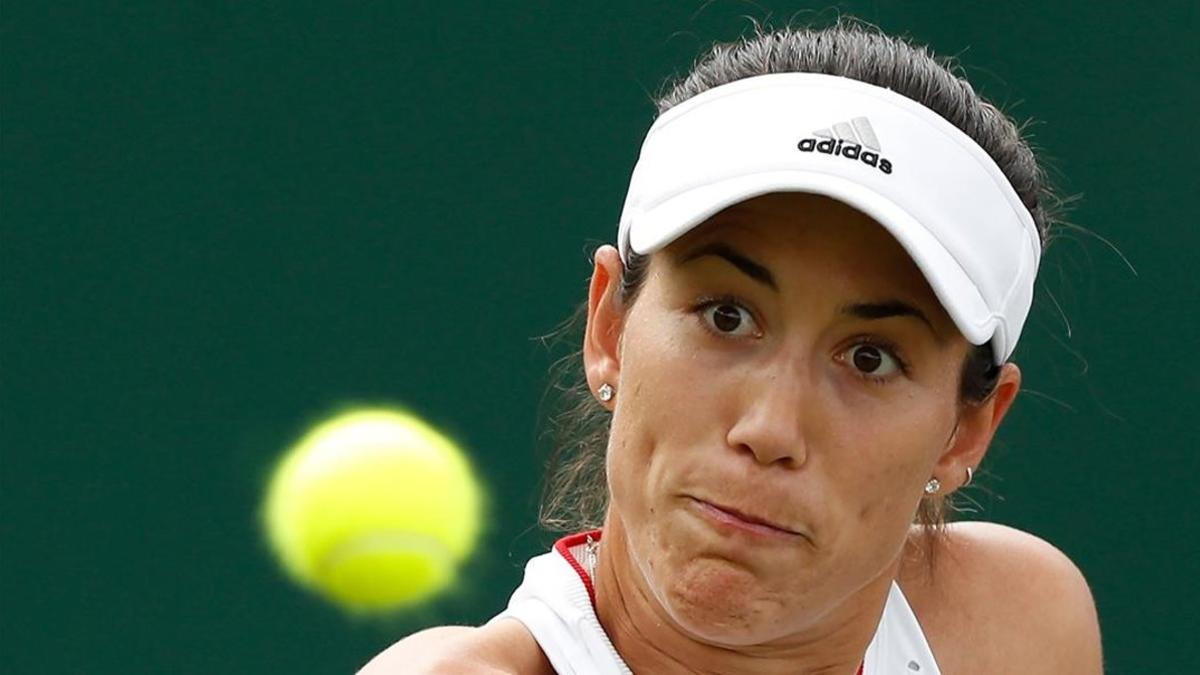 Garbine Muguruza returns the ball to Brazil s Beatriz Haddad Maia during their women s singles first round match on the second day of the 2019 Wimbledon