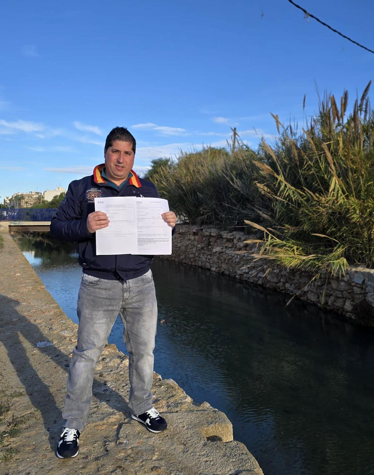 Sergio Boj muestra la solicitud registrada ante la Generalitat en una imagen junto al canal del Acequión