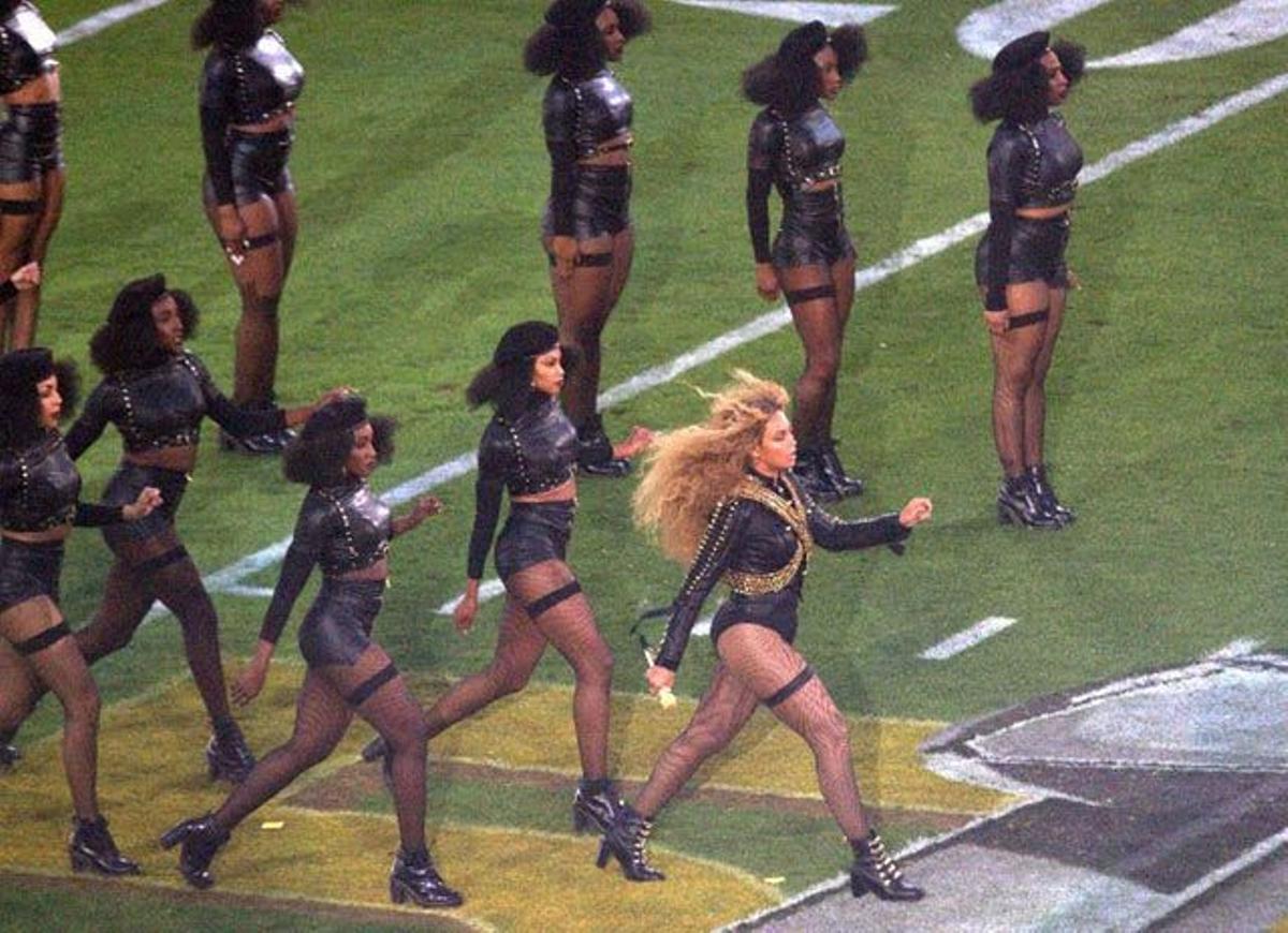 Beyoncé y su grupo de bailarinas sobre el césped del estadio durante su actuación en el descanso de la Super Bowl.