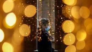 zentauroepp56062534 a woman wearing a protective mask is seen through a glass at201202171427