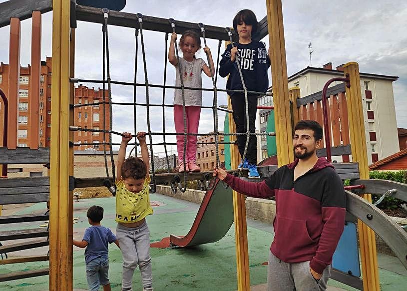 Los pequeños Gael, Naira y Uriel García con su padre, Iván, en el parque de la plaza de la República de El Coto.