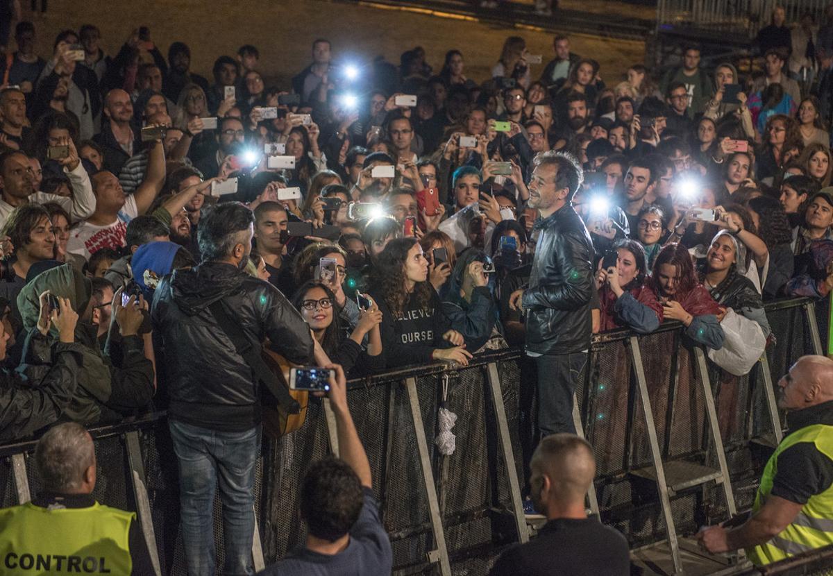 Santi Balmes y Julian Saldarriaga de Love of Lesbian bajan a pie de escenario para interpretar un par de temas para el público que esperó bajo la lluvia.