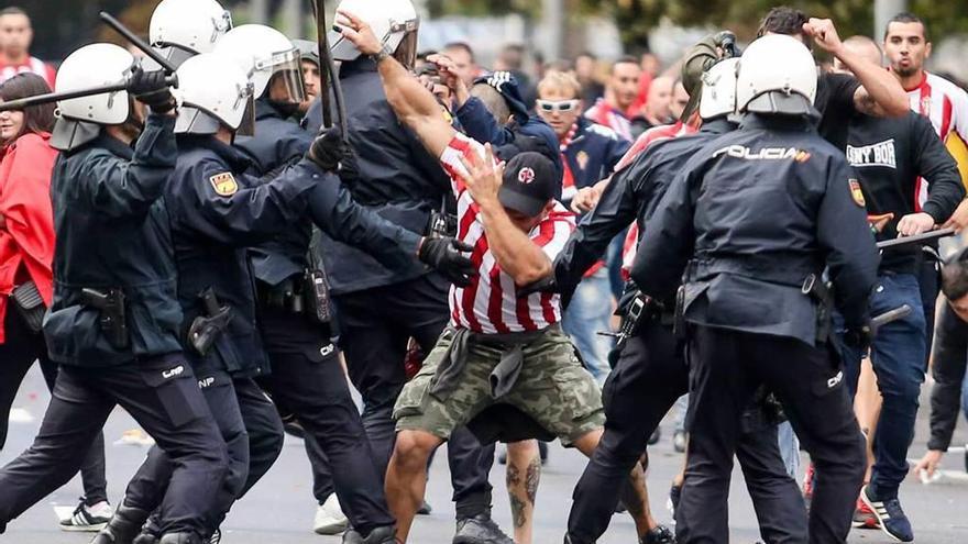 Un miembro de Ultra Boys, rodeado por la Policía durante los incidentes del último derbi en El Molinón.