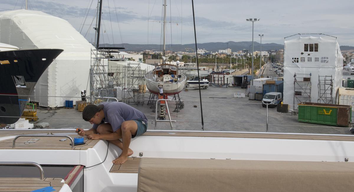 Un operario del varadero de Pendennis trabaja en uno de los barcos que se restauran y reparan en el Port de Vilanova i la Geltrú, el espacio donde se celebrará la regata preliminar de la Copa América de vela 2024, el próximo septiembre.