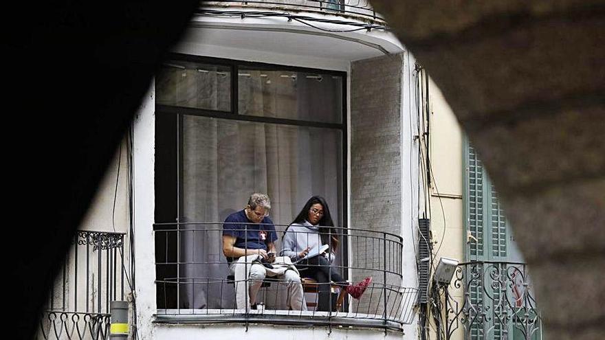 Una parella al balcó durant el confinament a Girona.