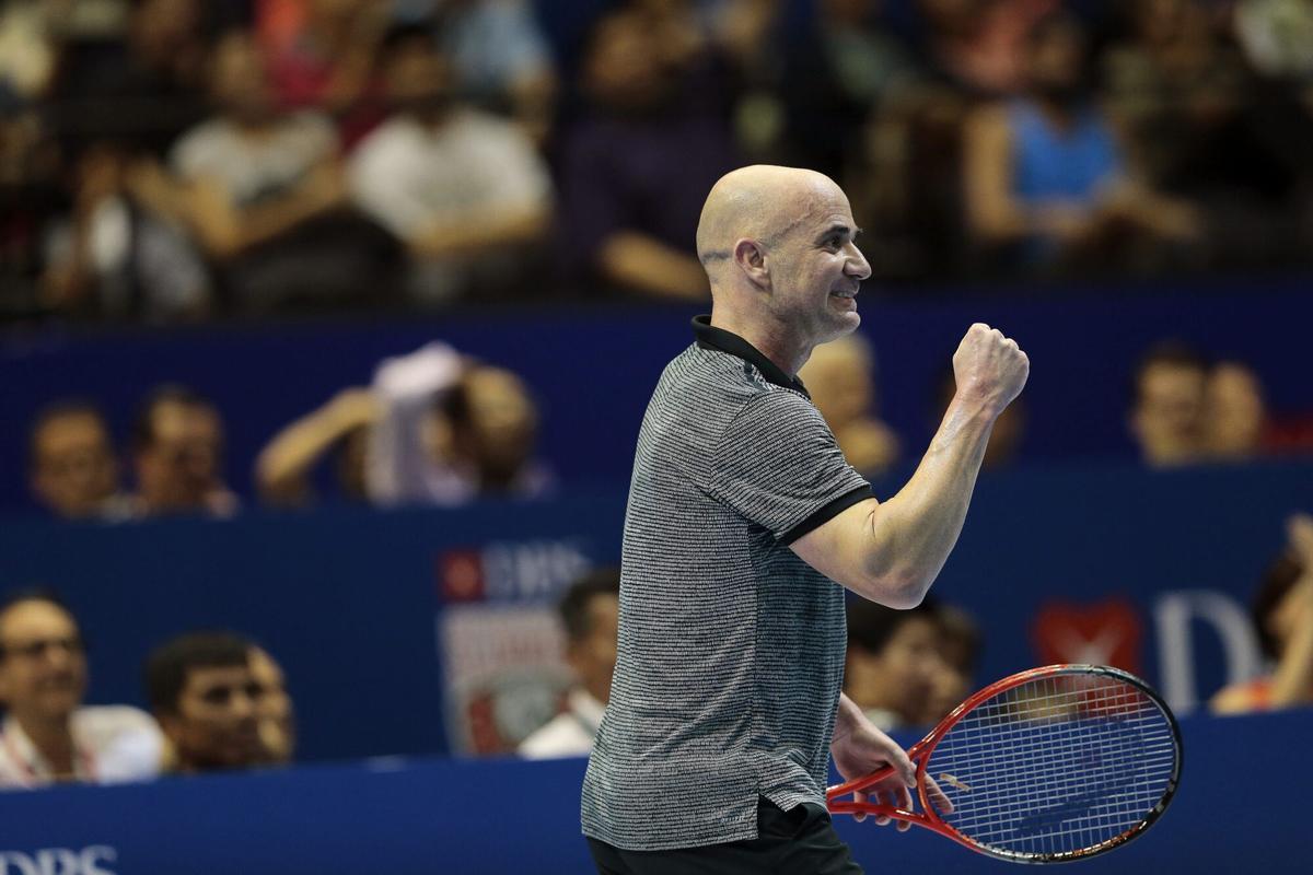 IPT13 SINGAPUR (SINGAPUR) 02/12/2014.- El tenista estadounidense Andre Agassi celebra un punto durante el partido contra el australiano Mark Philippoussis en la International Premier Tennis League (IPTL) en Singapur, hoy, martes 2 de diciembre de 2014. La IPTL, en la que participan cuatro equipos mixtos formados por tenistas retirados y en activo, celebra su segunda etapa en el país asiático tras comenzar en Filipinas y pasará por Nueva Deli antes de concluir en Dubai. EFE/Wallace Woon. HORIZONTAL