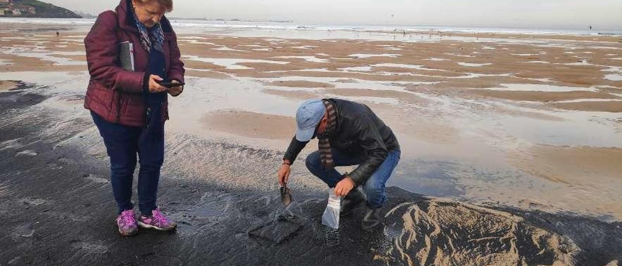 Dos científicos del Incar toman muestras de un vertido de carbón en San Lorenzo el pasado mes de diciembre.