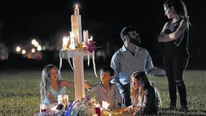 Una familia recuerda a una de las 17 víctimas de la matanza, ante el instituto de Parkland, en Florida.