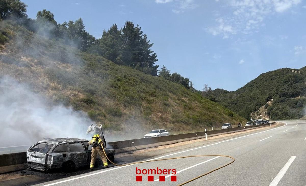 Els Bombers acabant de sufocar l'incendi del cotxe a l'Eix al seu pas per Sant Hilari Sacalm.