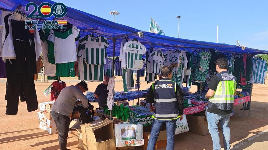 Agentes de la Policía Nacional se incautan de las camisetas del Córdoba CF en uno de los puestos intervenidos, el pasado viernes, junto a El Arcángel.