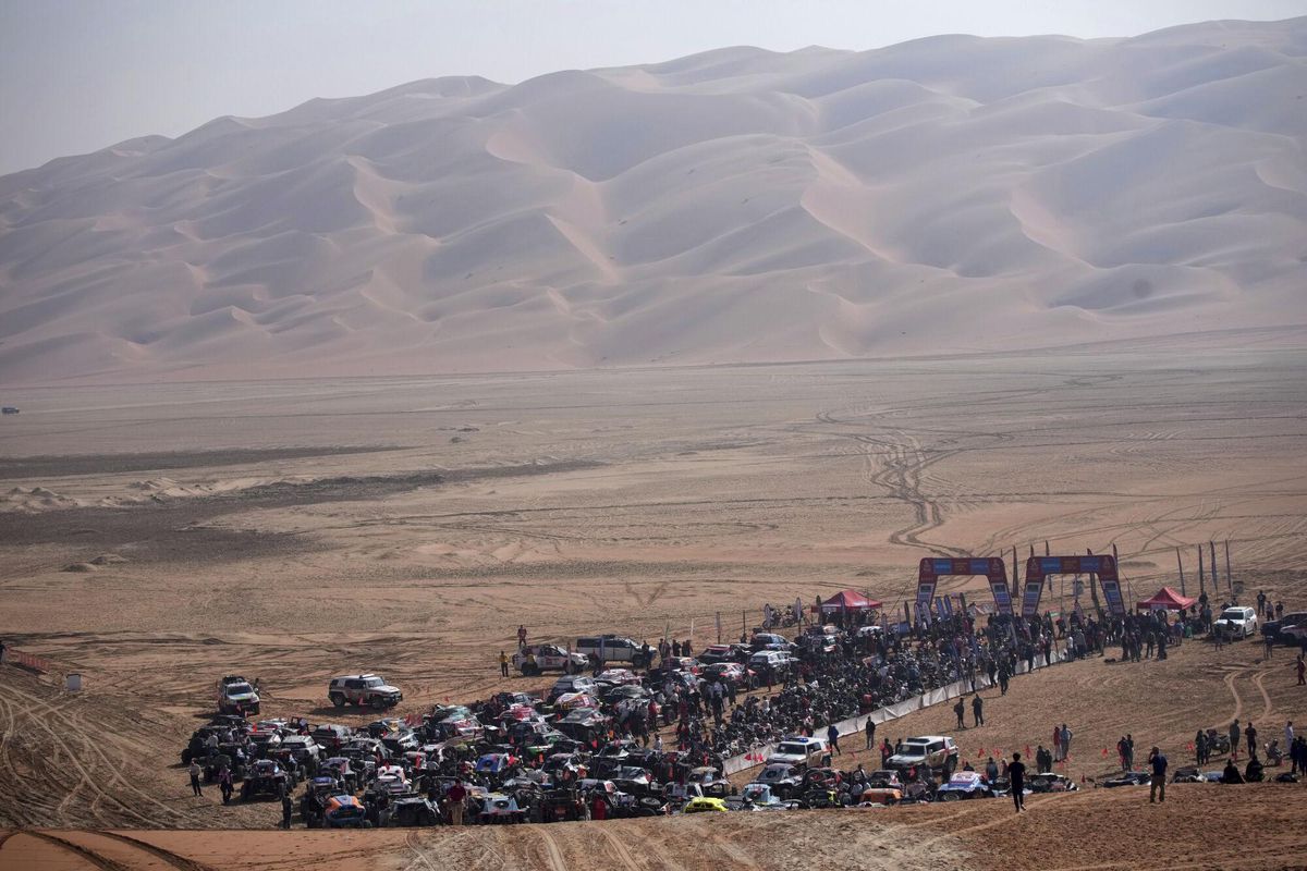 Competitors gather at the start delayed due to fog during the eleventh stage of the Dakar Rally with start and finish in Shubaytah, Saudi Arabia, Thursday, Jan. 16, 2025. (AP Photo/Christophe Ena)